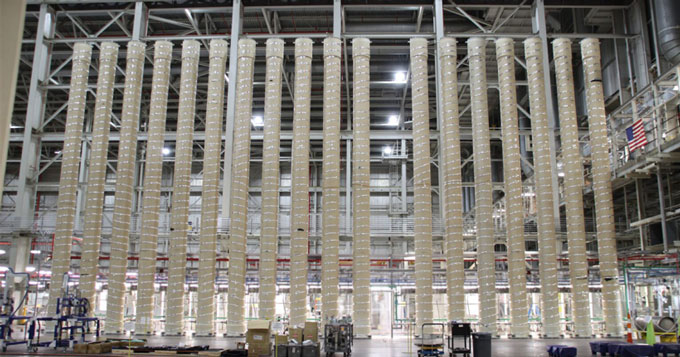 A uranium processing facility with tall tubes stretching up to the ceiling